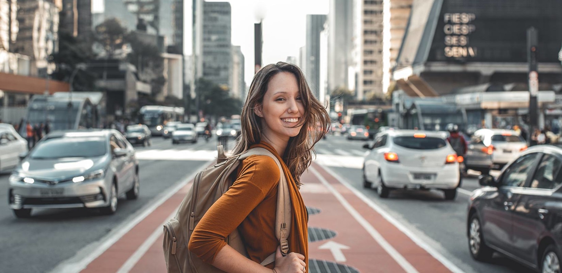 travelling girl on city street with cars