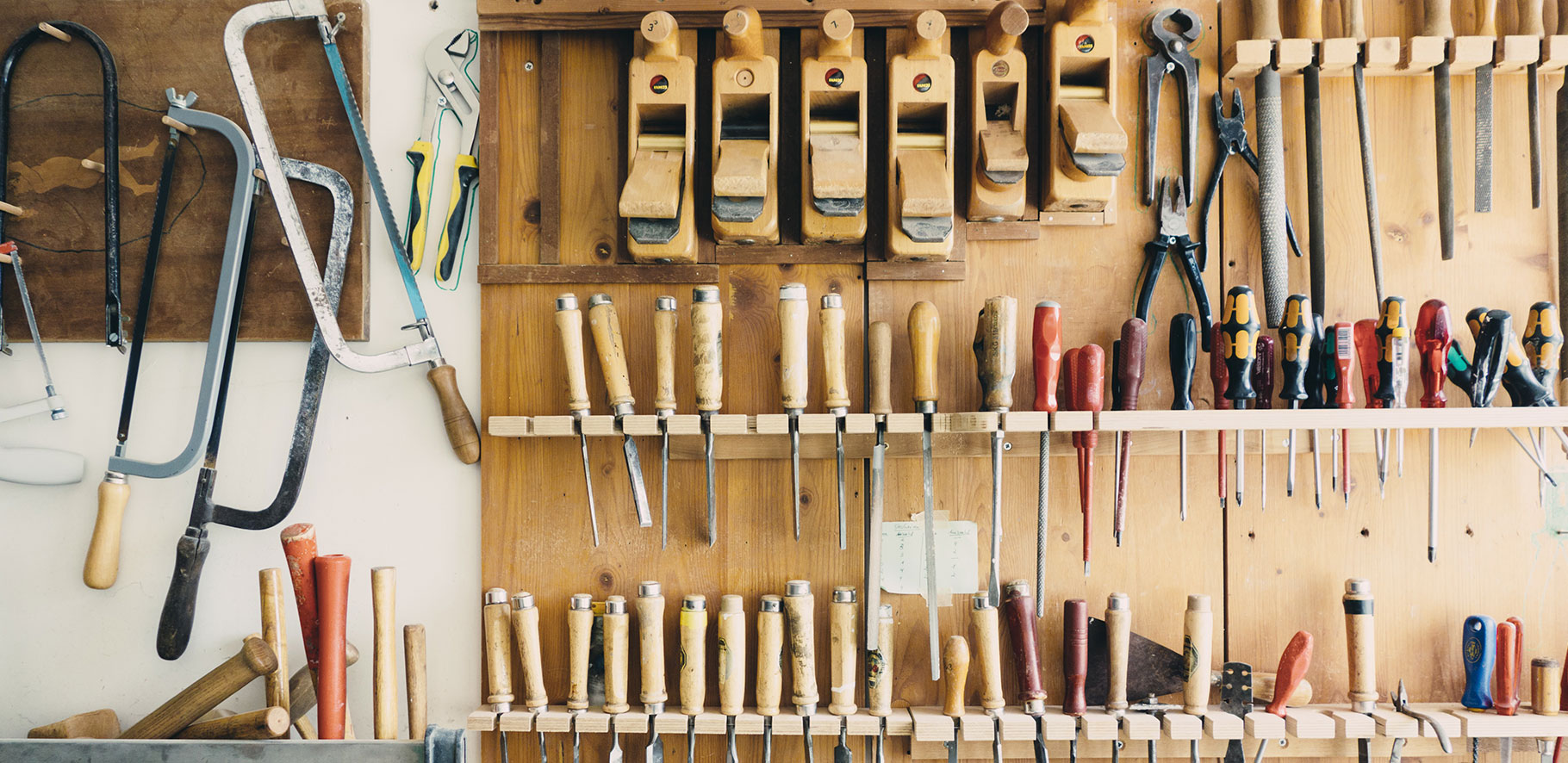 workshop with lots of tools hanging on the wall