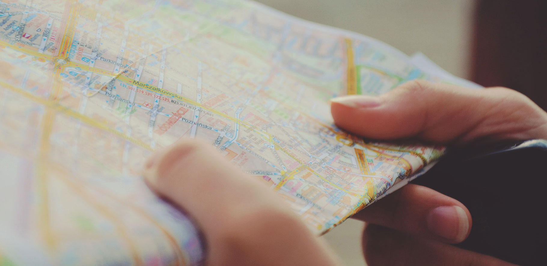 close up of a person holding a street map